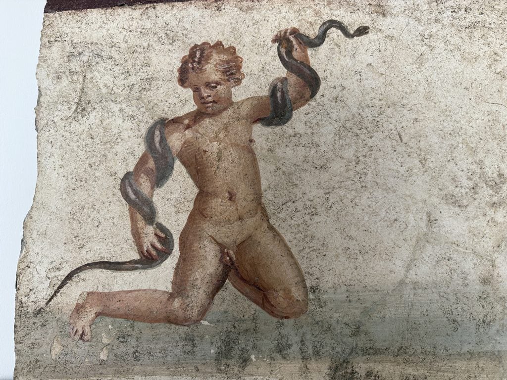 Detail of fresco in which baby Hercules wrestles a snake. Image courtesy the Archaeological Park of Pompeii.