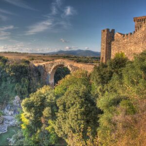 Castello della Badia and the ancient Abbadia bridge over the Fiora River gorge at Vulci, Italy