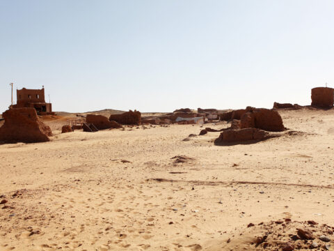Eroded mud-brick tomb ruins in the sand at the Bir el-Shaghala necropolis near Mut in Egypt's Dakhla Oasis