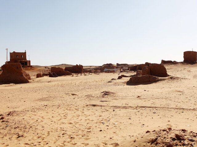 Eroded mud-brick tomb ruins in the sand at the Bir el-Shaghala necropolis near Mut in Egypt's Dakhla Oasis